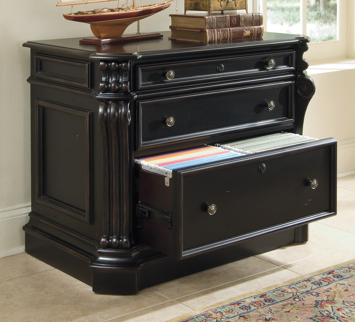 a black dresser with a boat on top