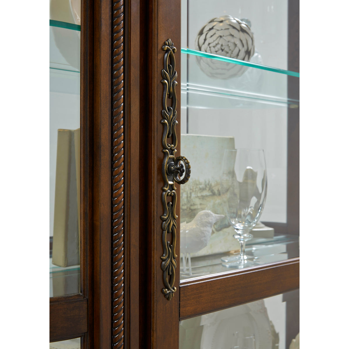 a glass cabinet with a door handle
