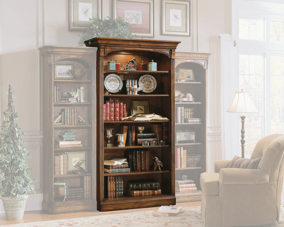 a bookcase with books and a lamp in a room