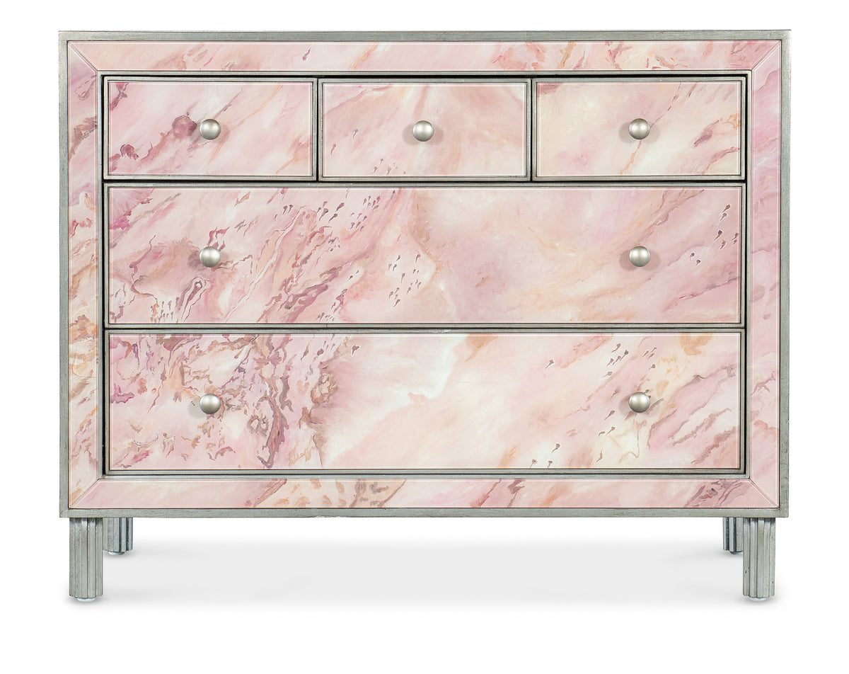 a pink dresser with silver legs