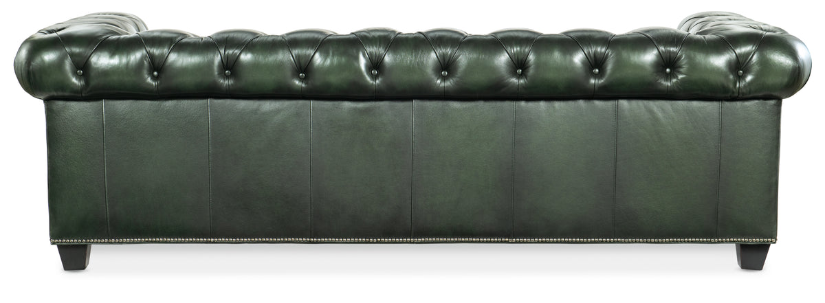 a green leather couch with buttons