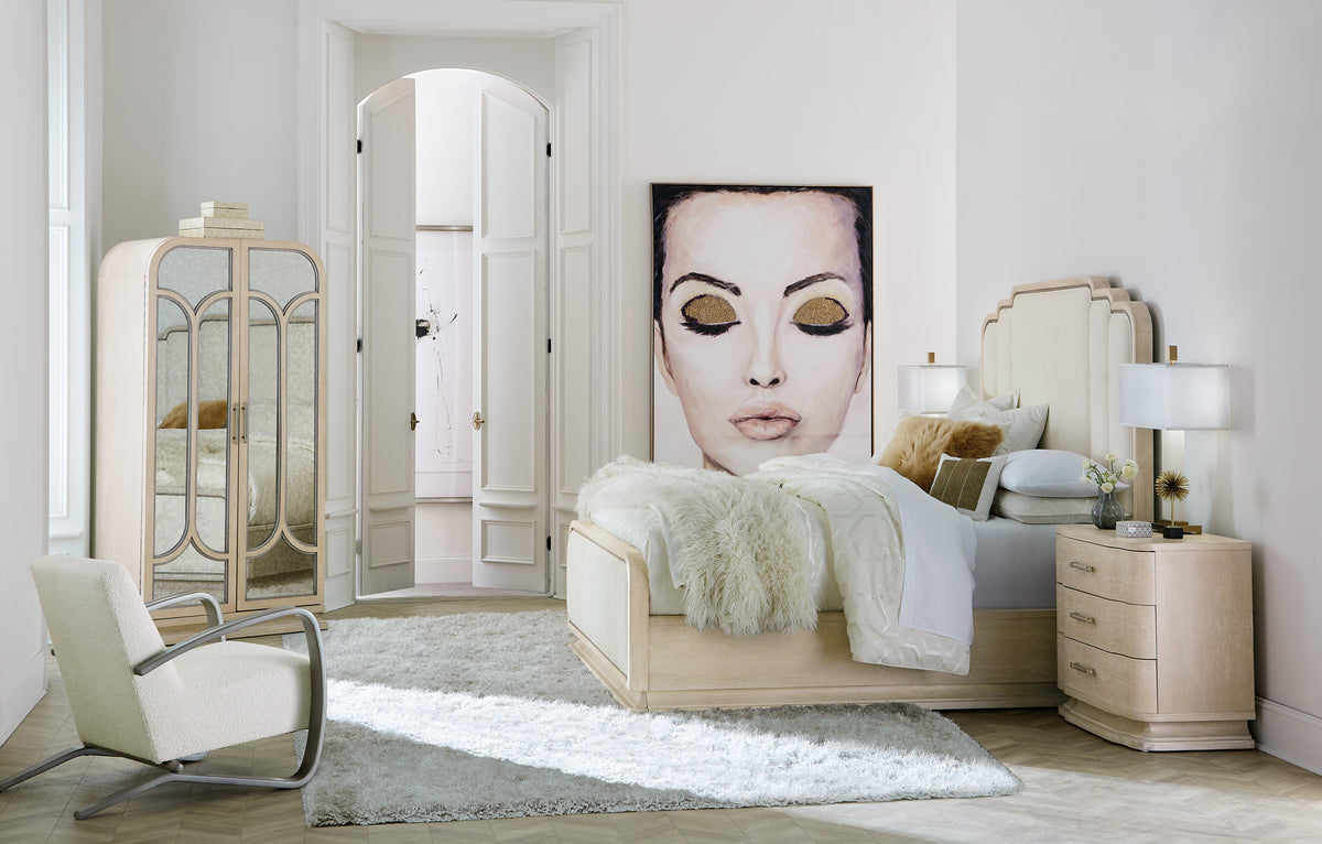 a bedroom with a large painting of a woman's face