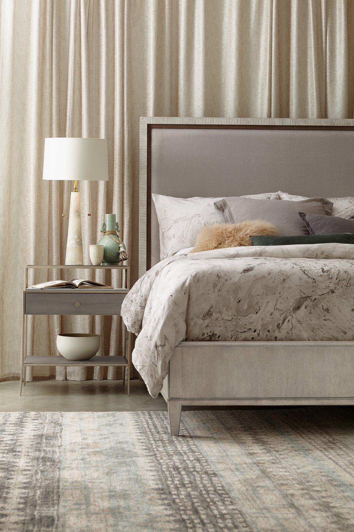 a bed with a lamp next to it
