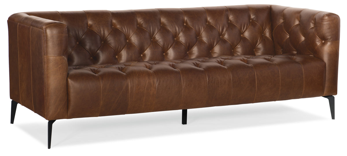 a brown leather couch with black legs