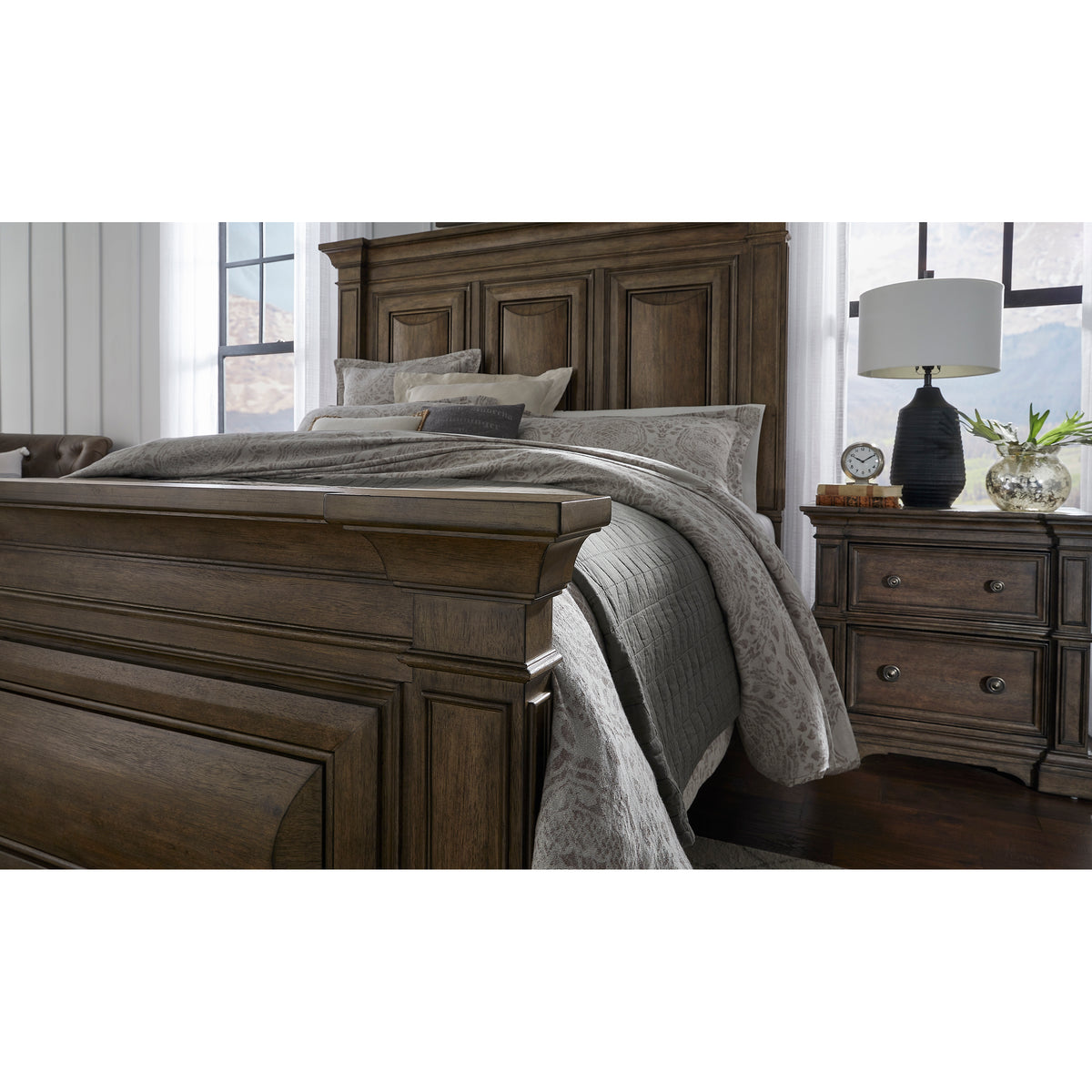a bed with a lamp and a night stand