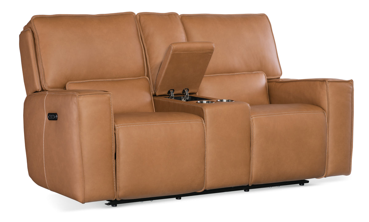 a brown leather couch with a drink holder