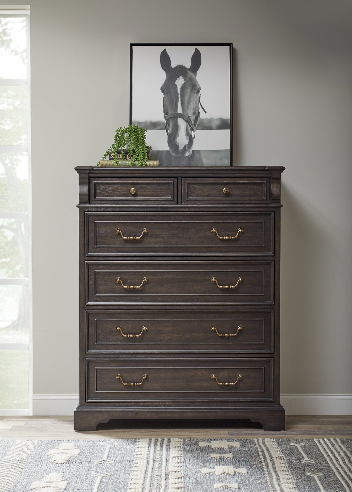 a dresser with a picture of a horse on top