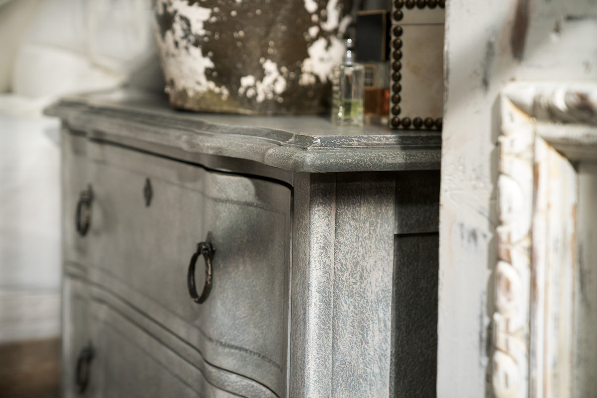 a grey dresser with a pot on top