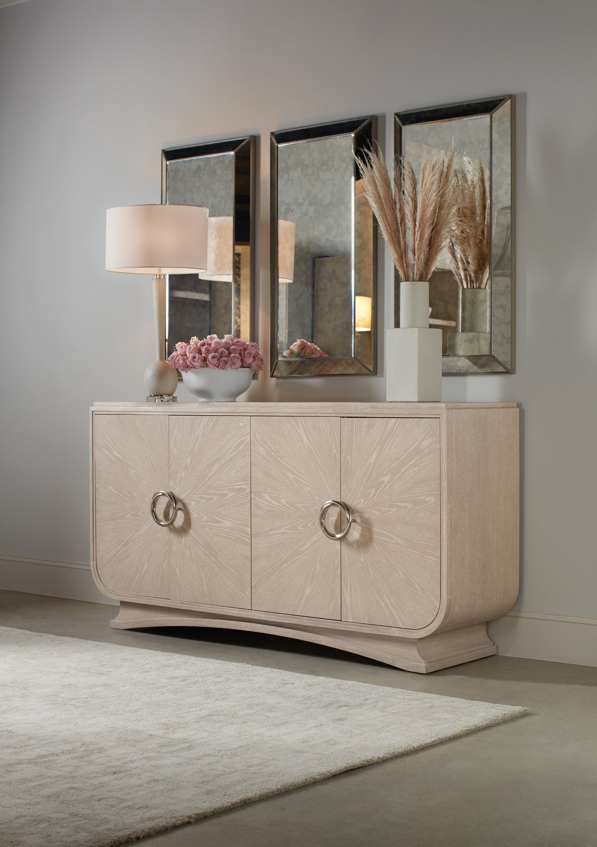 a white dresser with a lamp and flowers on top