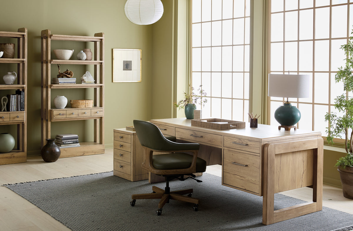 a desk in a room with a chair and shelves
