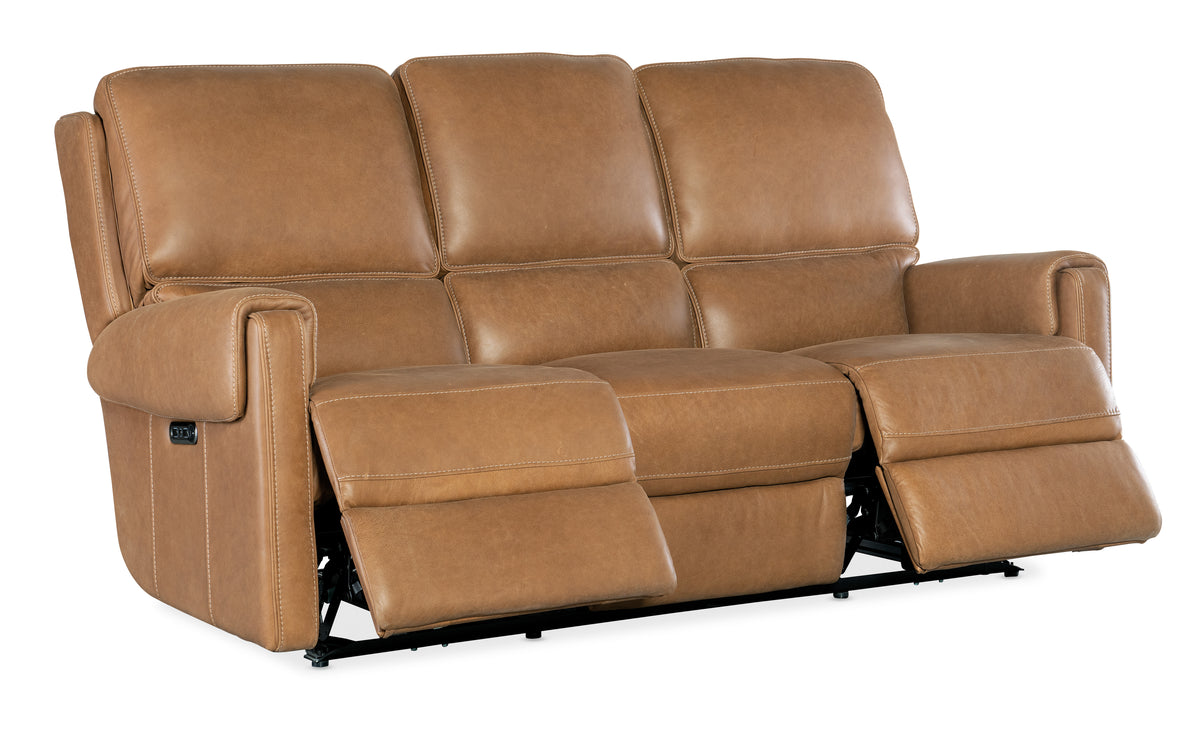 a brown leather couch with two recliners