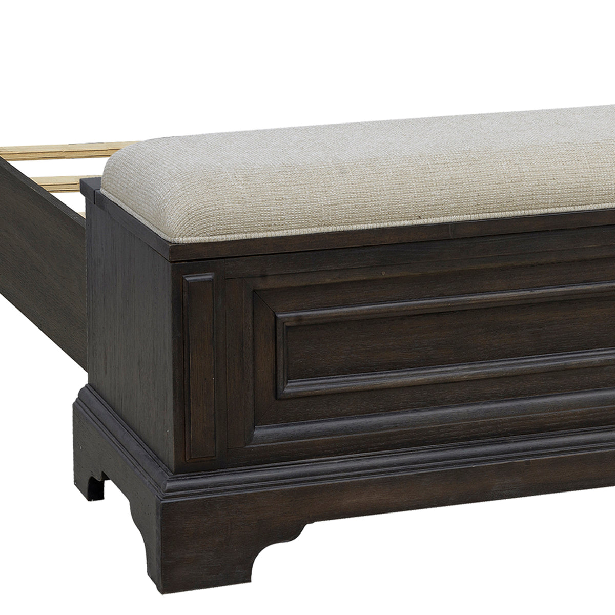 a wooden bed with a white cushion