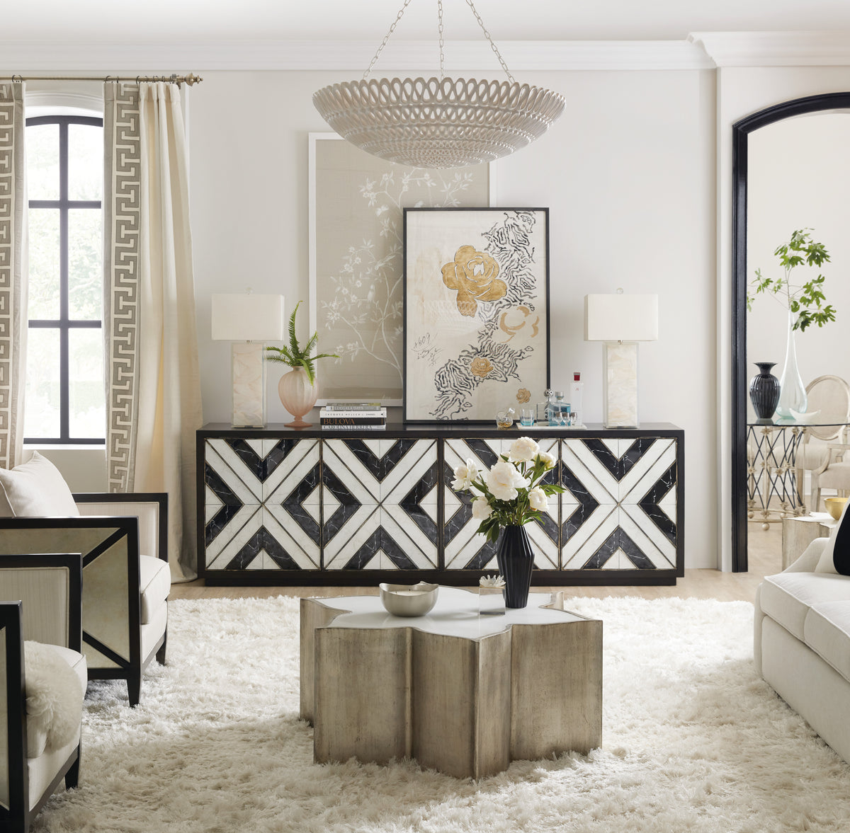 a living room with a white rug and a black and white patterned cabinet