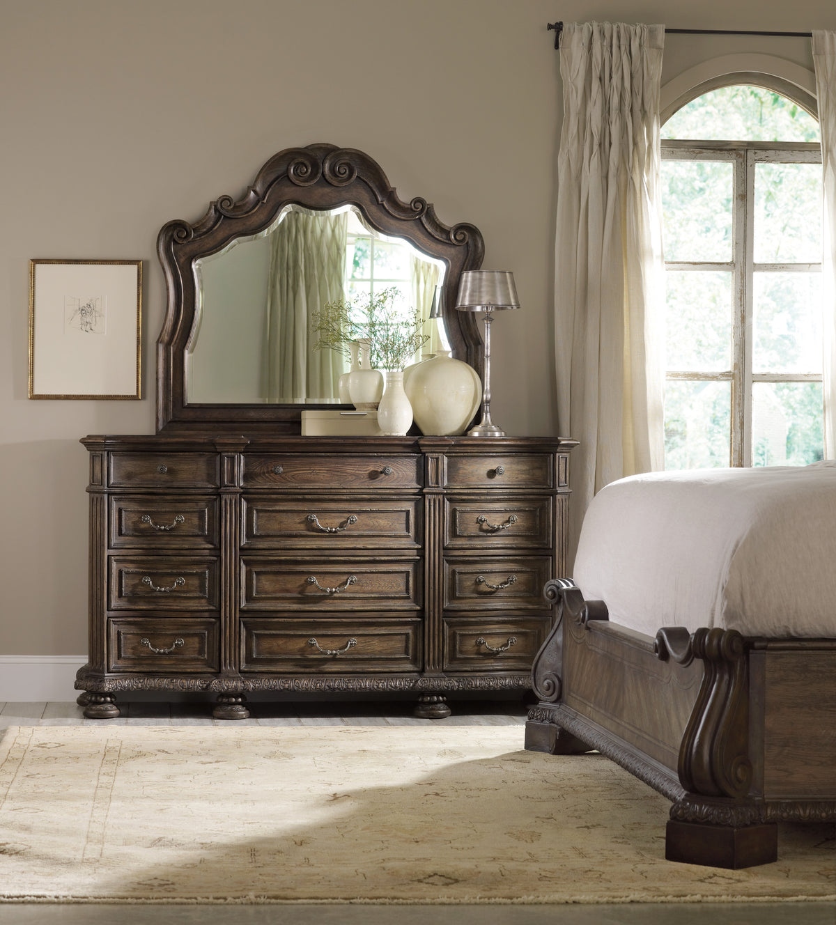 a dresser with a mirror and a bed