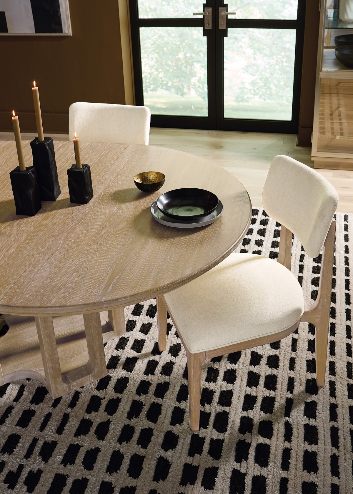 a table with candles and a bowl on it