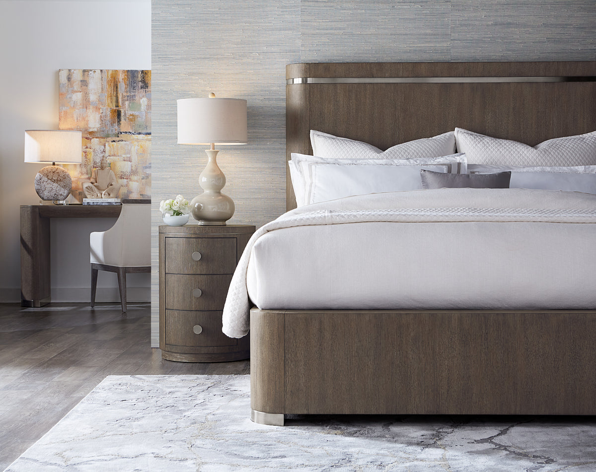a bed with a lamp next to it