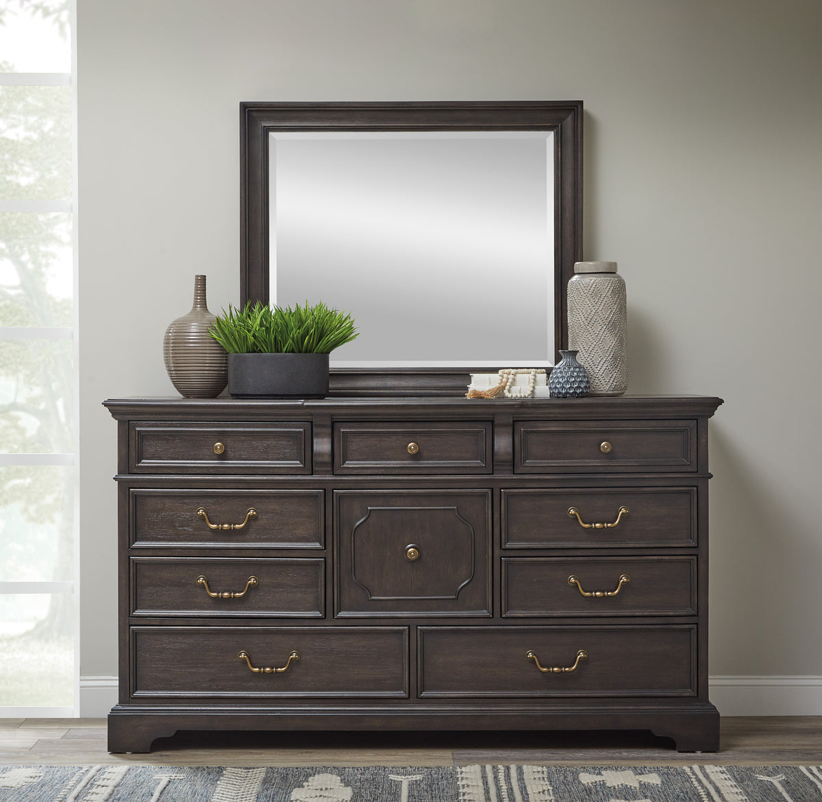 a dresser with a mirror and vases on top