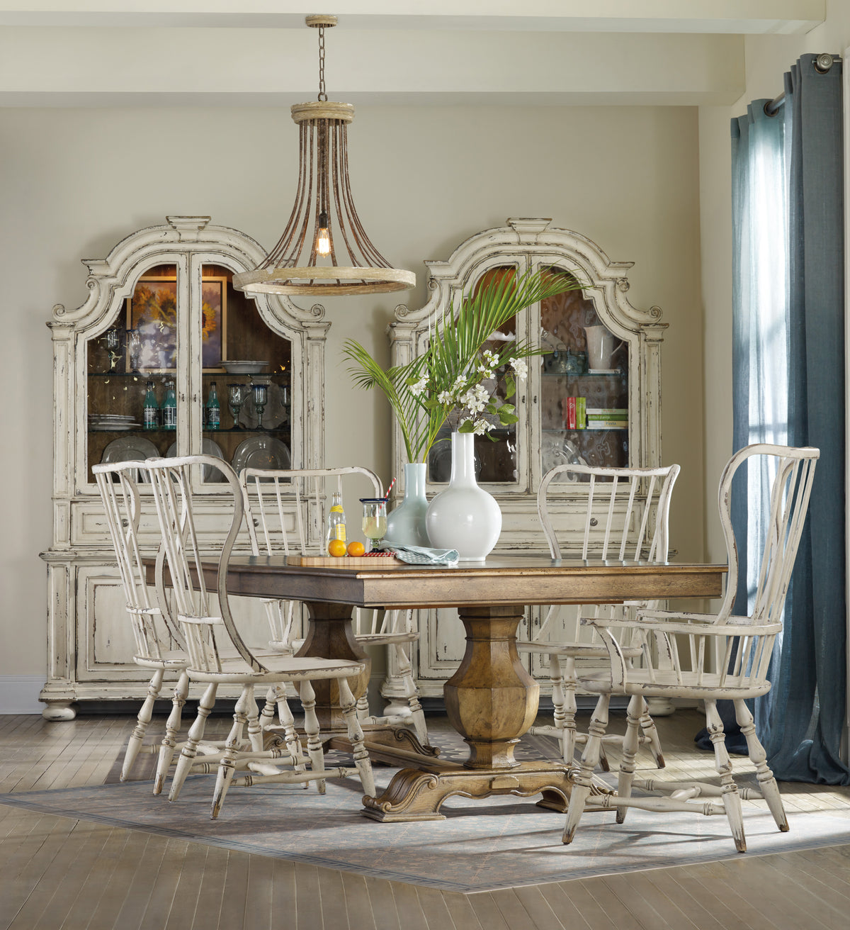 a dining room table with chairs and a chandelier