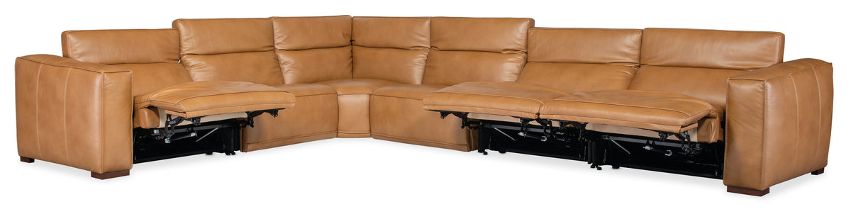 a brown leather couch with a foot rest