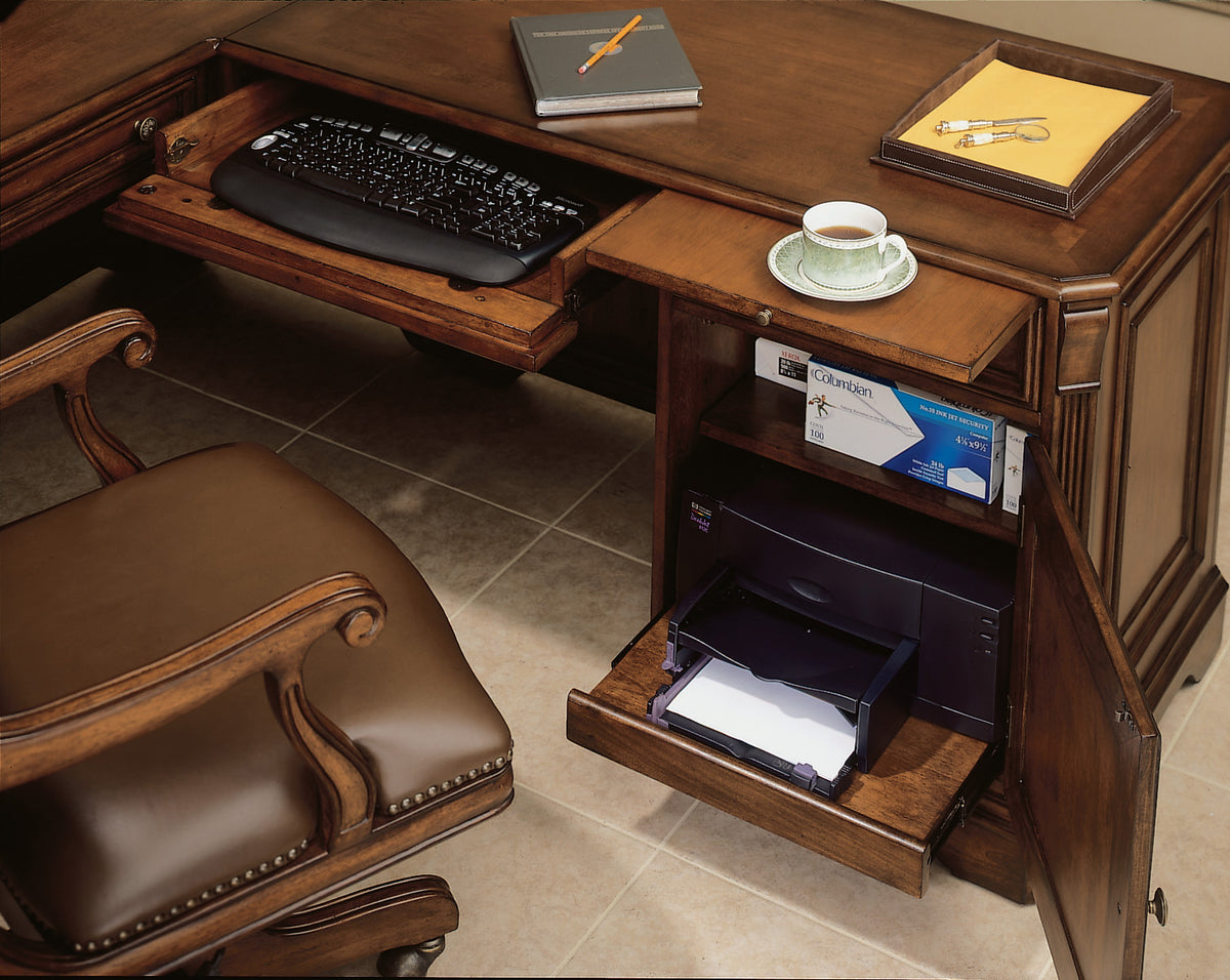 a desk with a keyboard and a cup of coffee