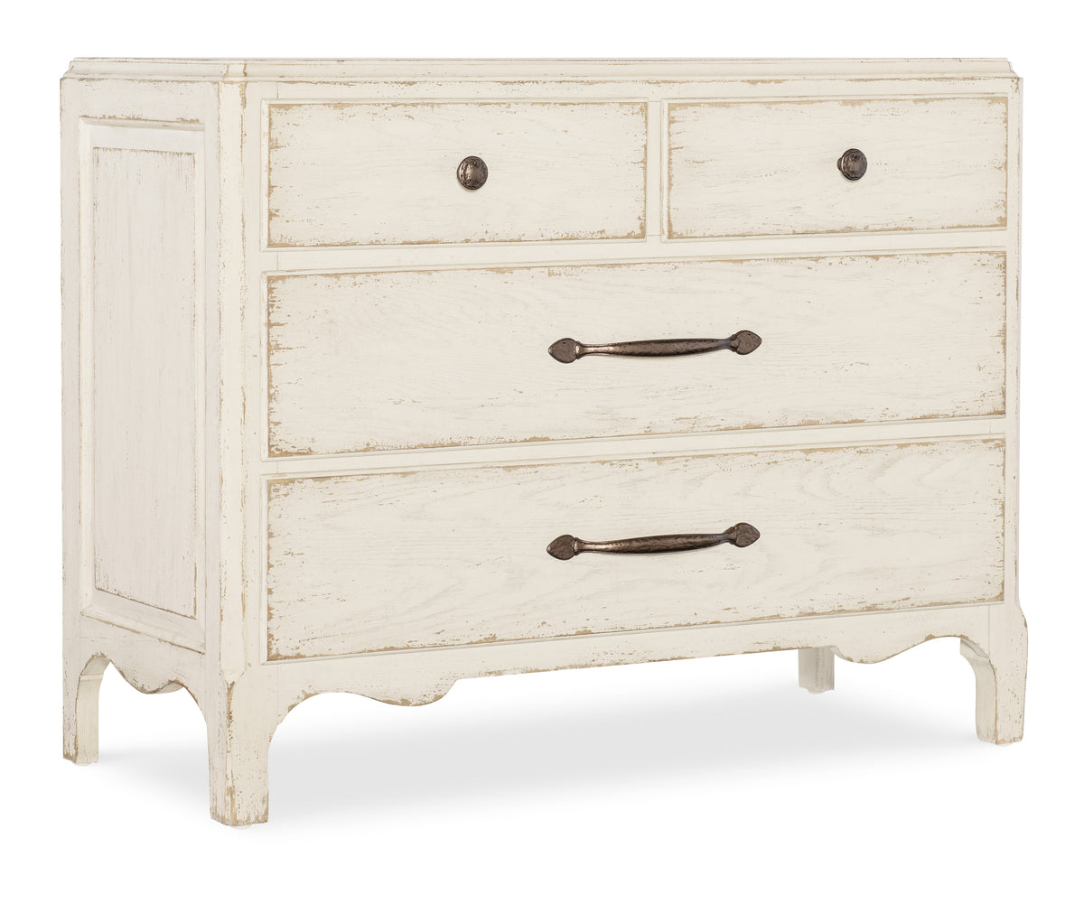 a white dresser with black handles