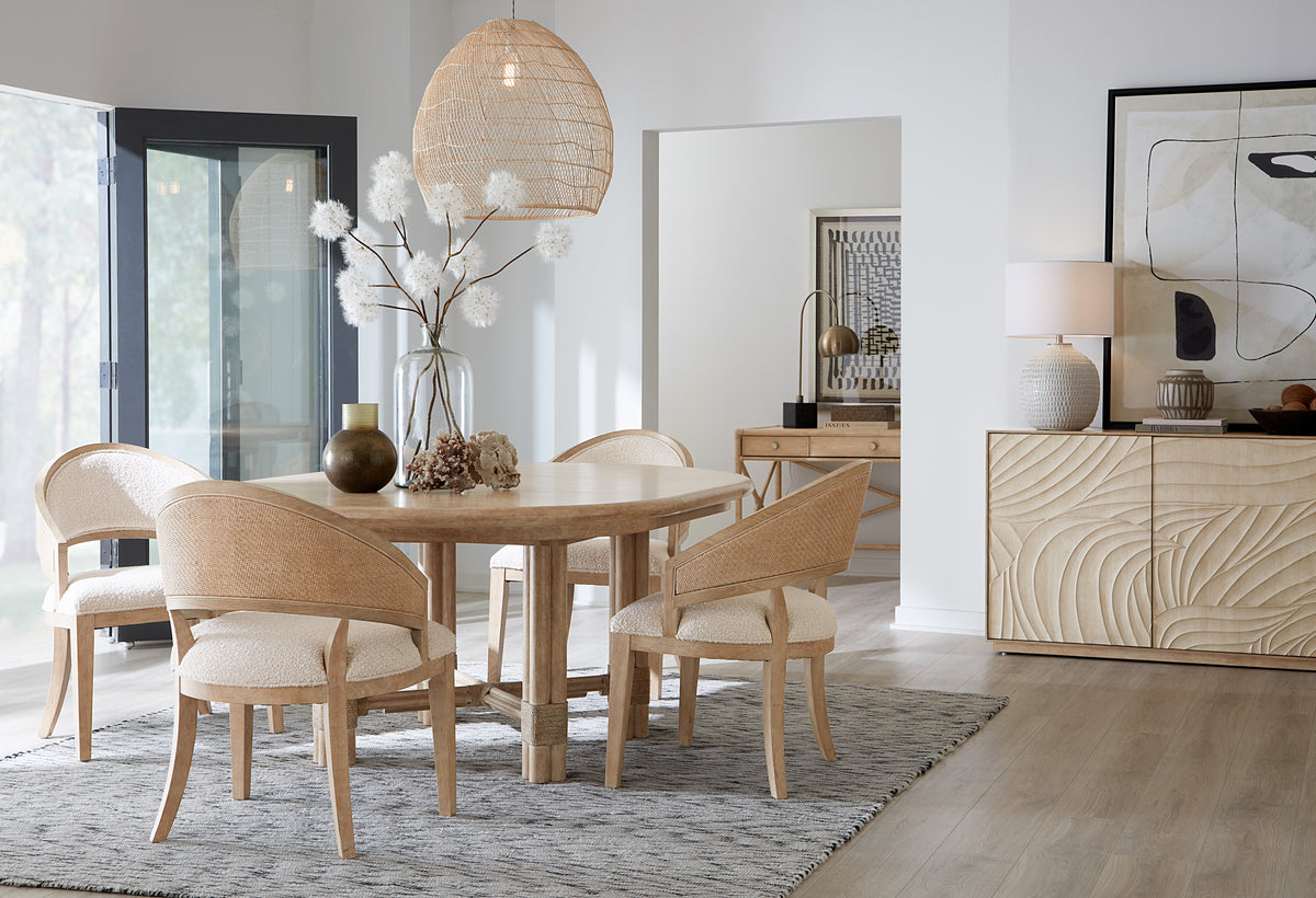 a dining table with chairs and a vase of flowers
