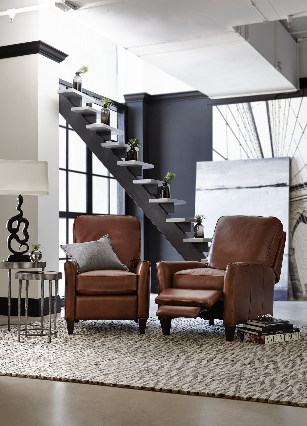 a room with a staircase and chairs