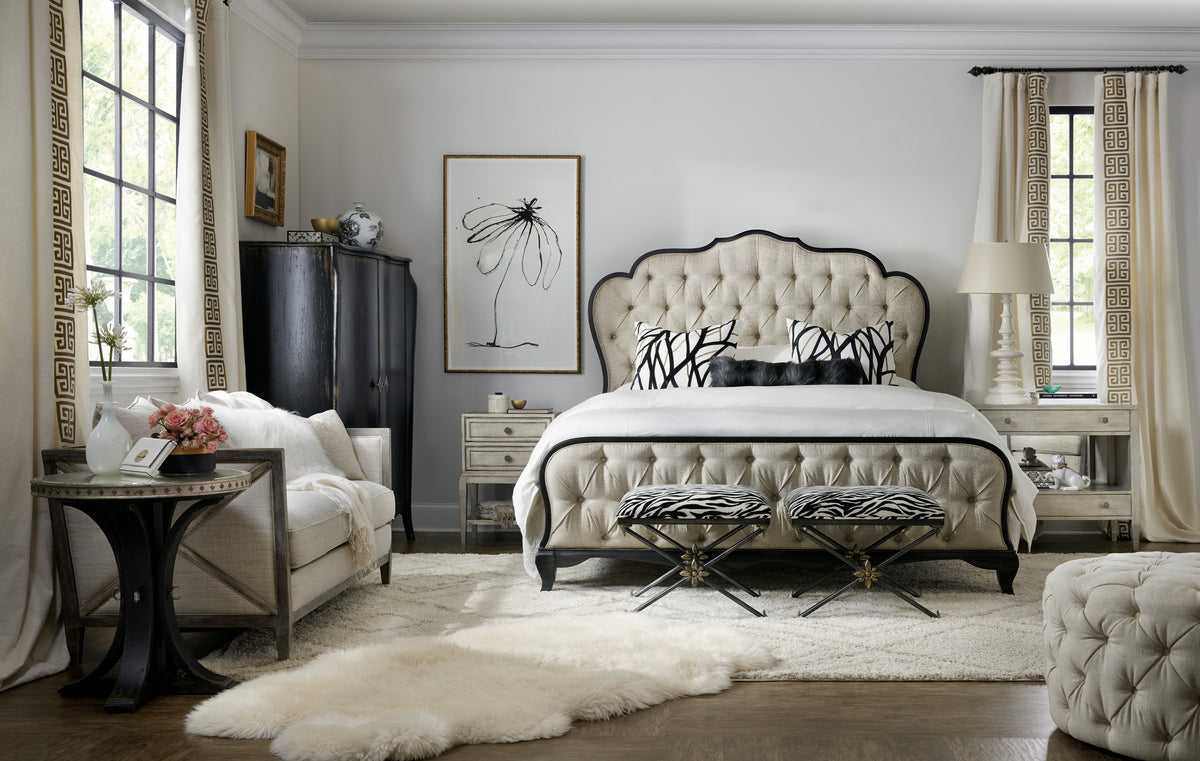 a bedroom with a bed and a chair