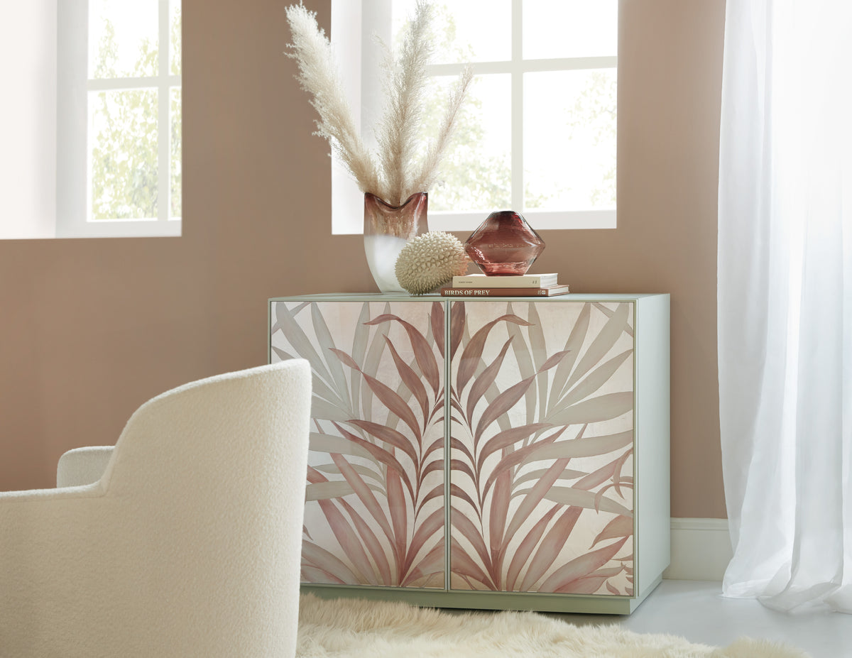 a white and pink cabinet with a vase and vase on top