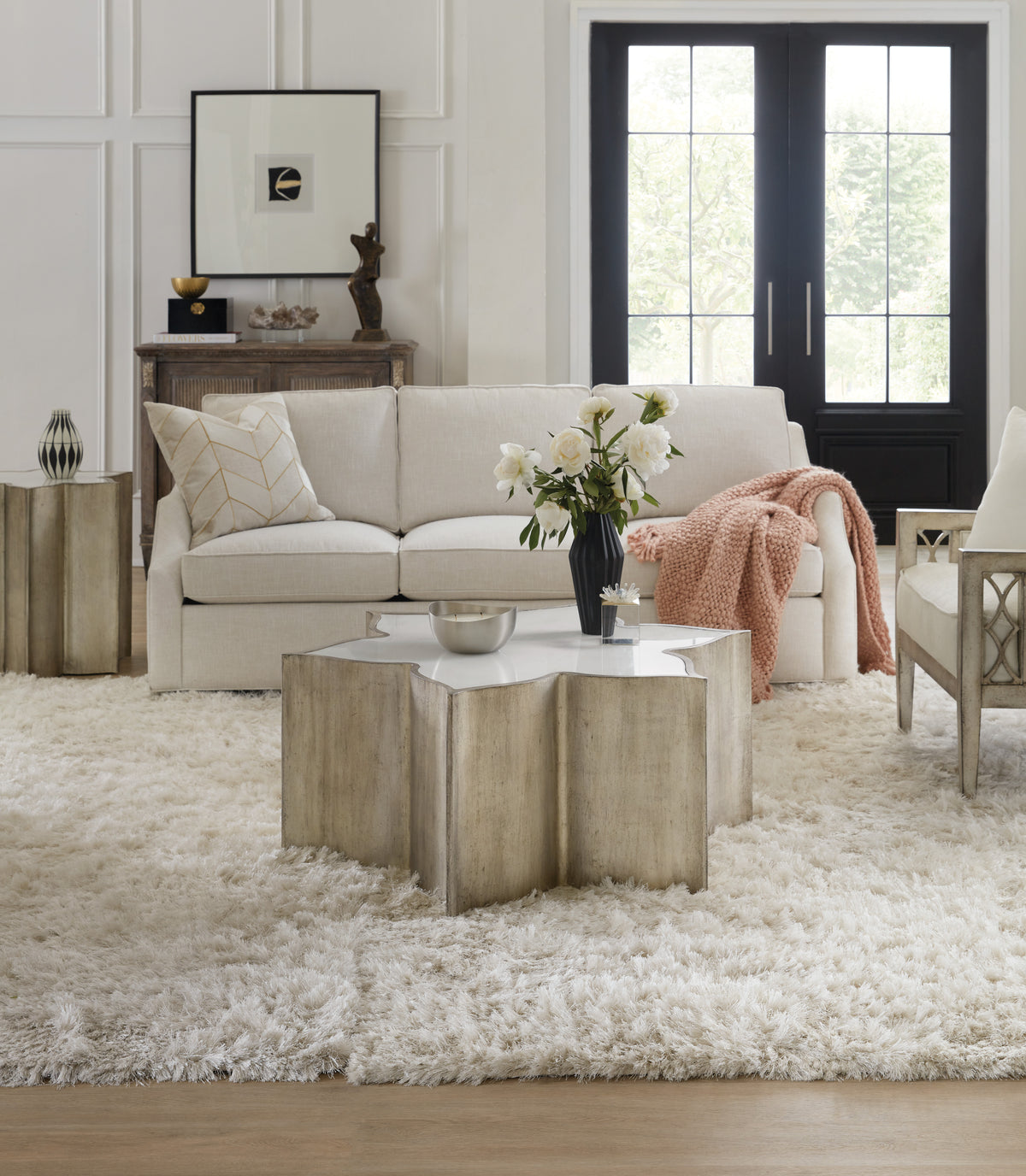 a living room with a white couch and white rug