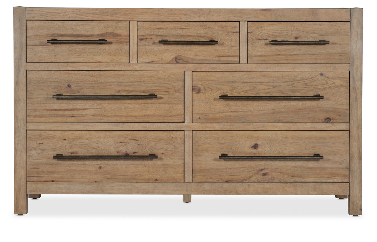 a wooden dresser with black handles