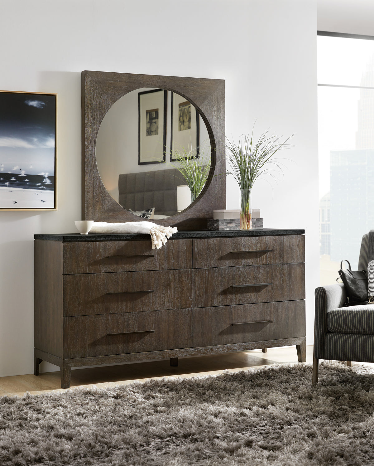 a dresser with a mirror and a chair in a room