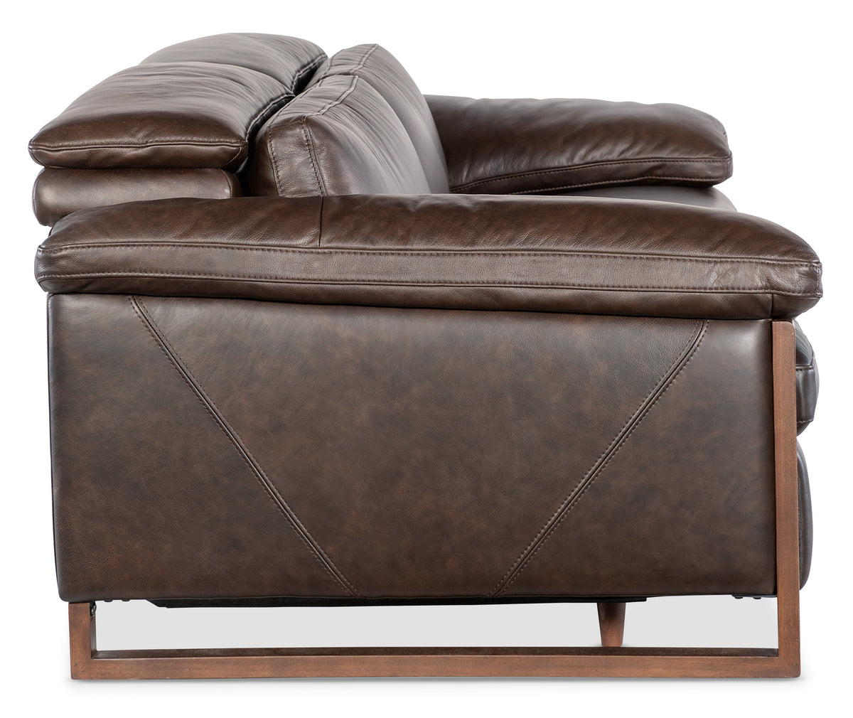 a brown leather couch with wooden legs
