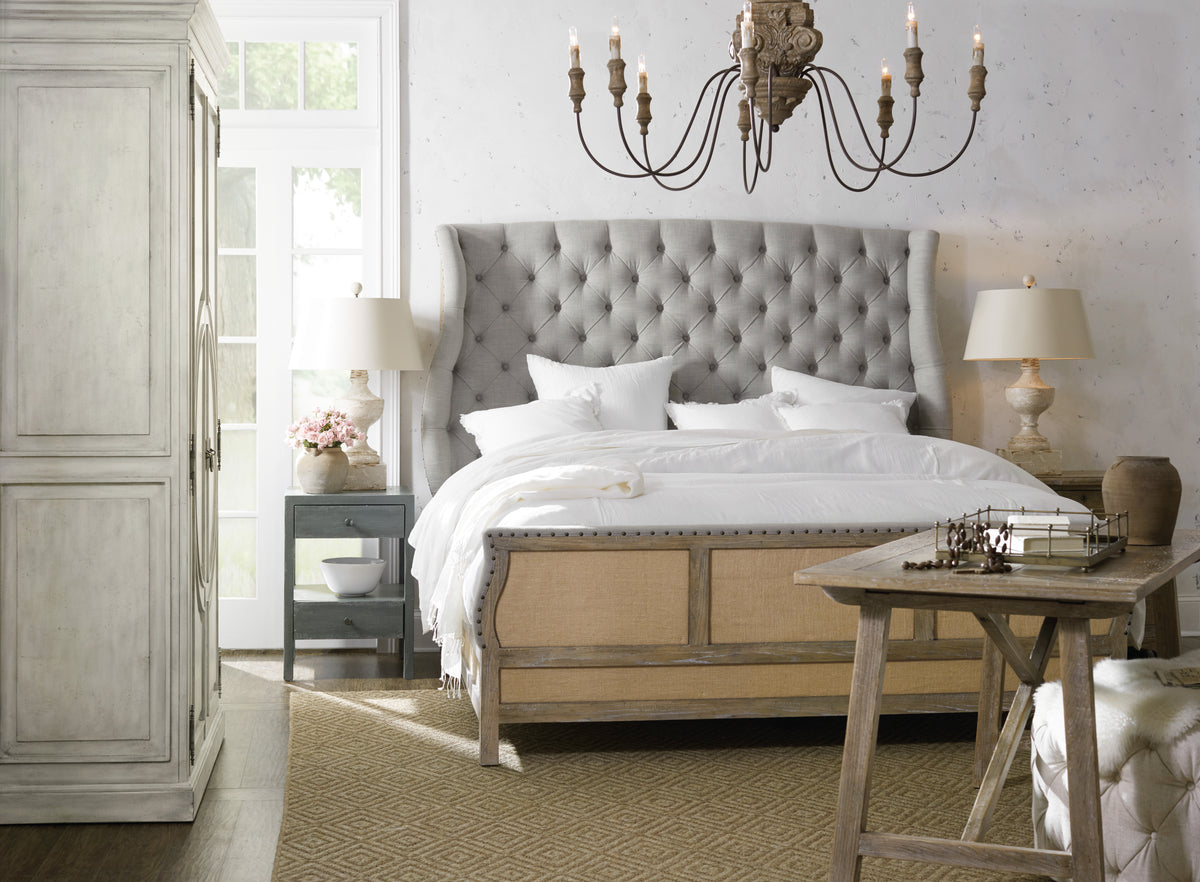 a bed with a chandelier in the background