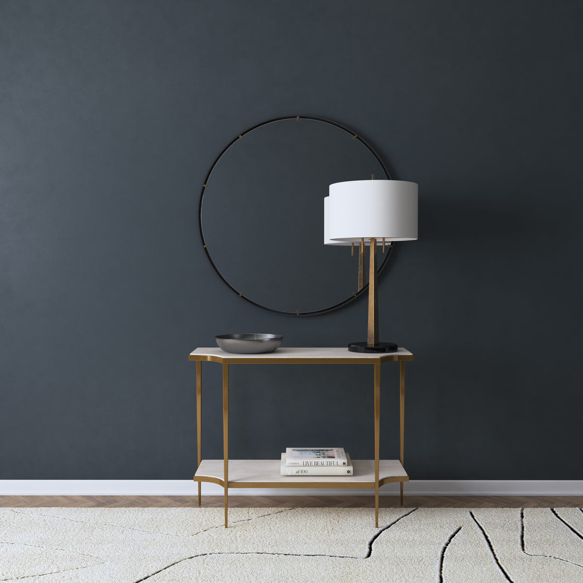 a table with a lamp and a round mirror on the wall