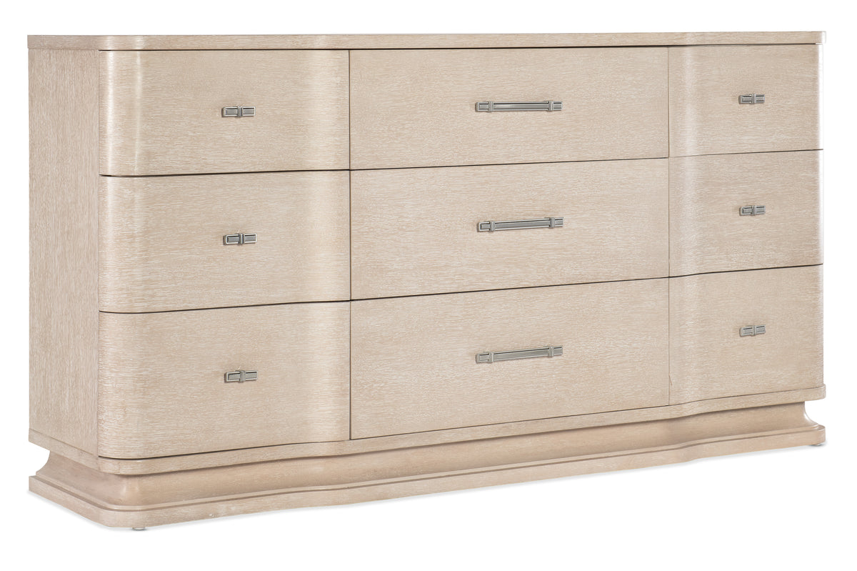 a white dresser with silver handles