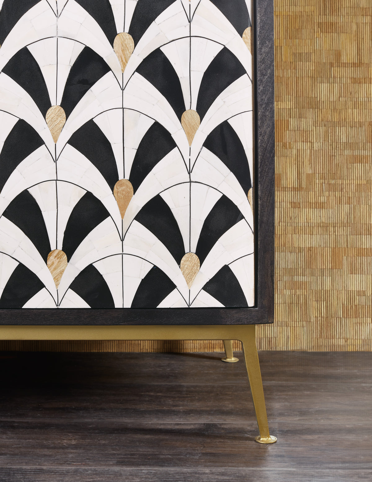 a black and white art deco pattern on a wood surface