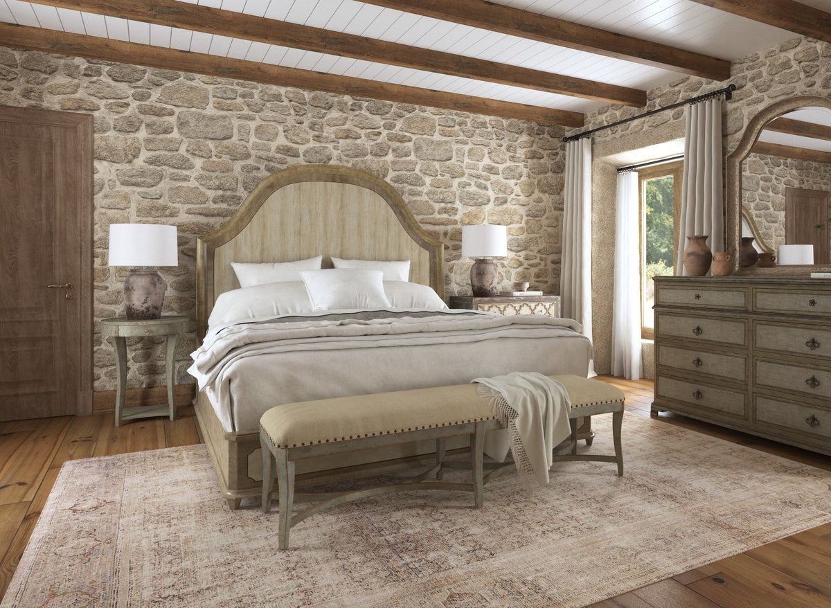 a bedroom with a stone wall and a bed