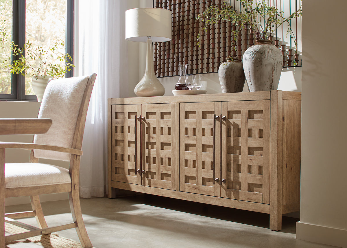 a wooden cabinet with a lamp and vases on it