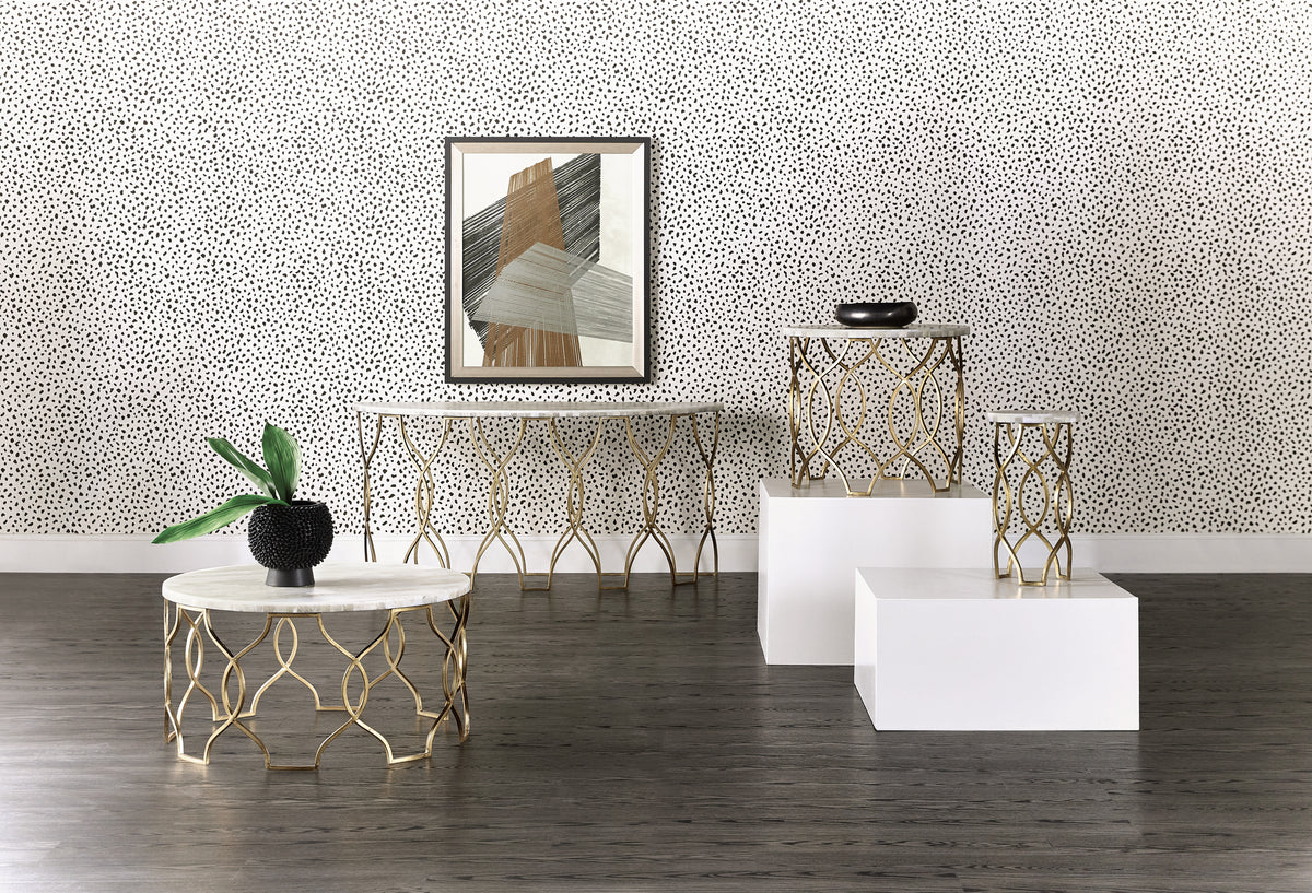 a room with white and gold tables and a picture on the wall