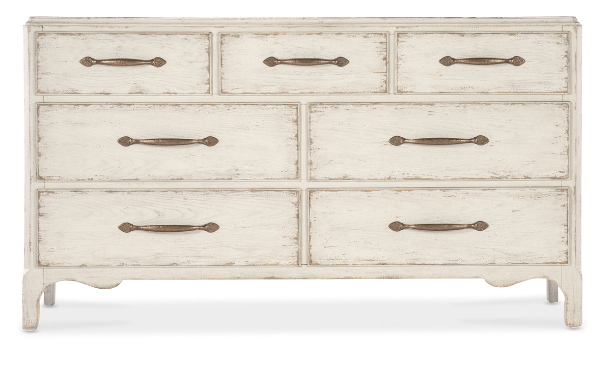 a white dresser with metal handles