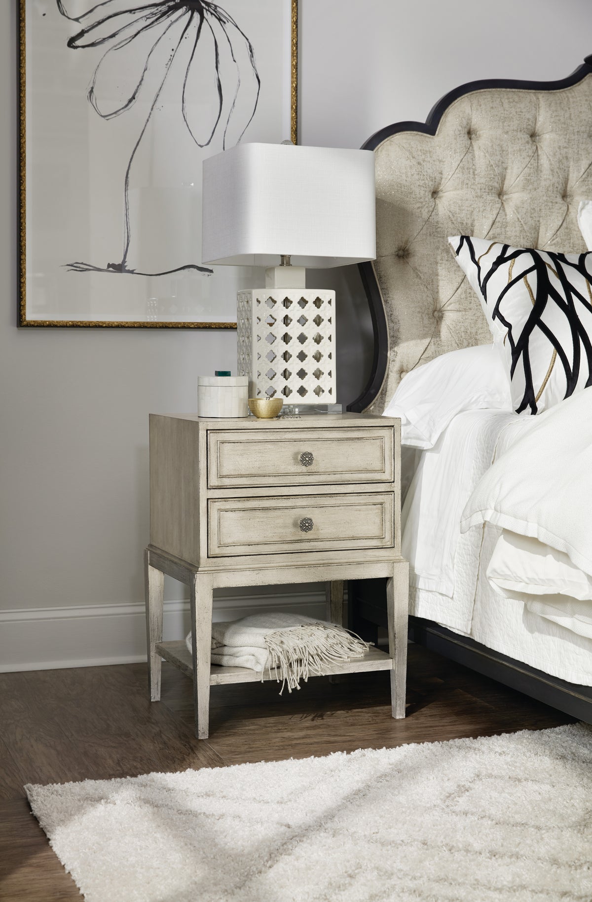 a nightstand with a lamp on it