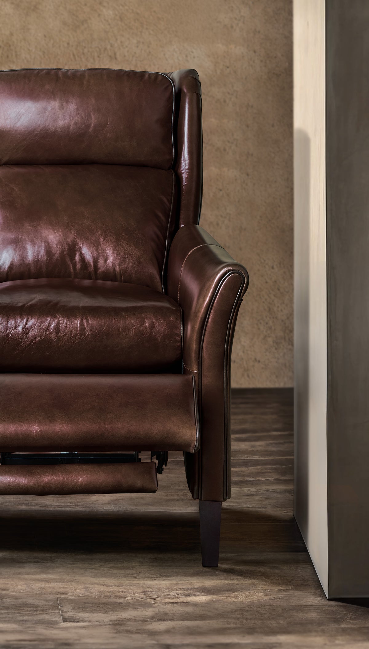 a brown leather chair in a room