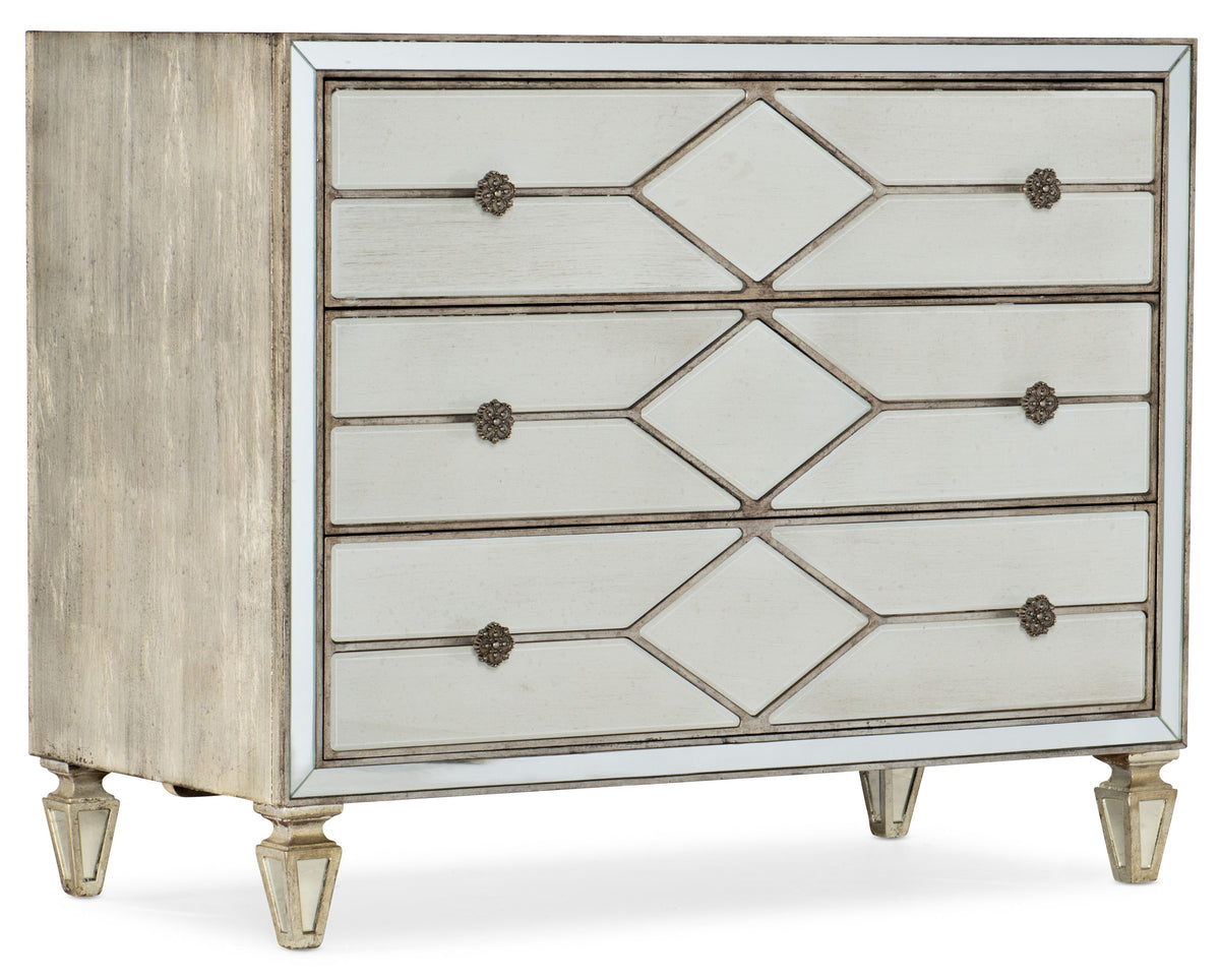 a white dresser with gold trim