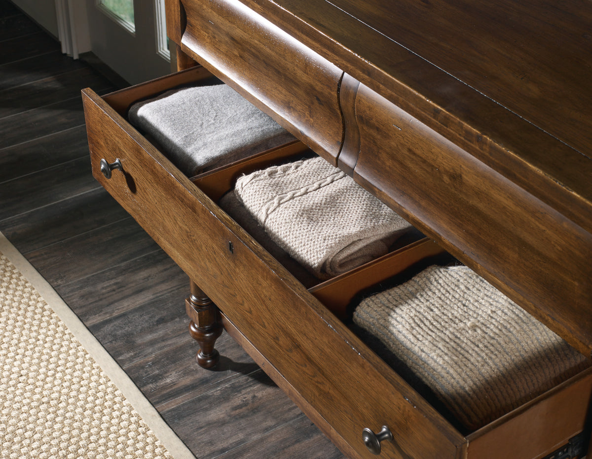 a drawer with folded blankets and blankets inside