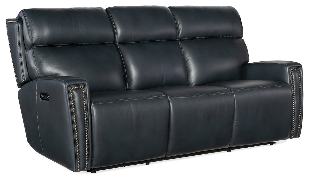 a black leather couch with gold studs