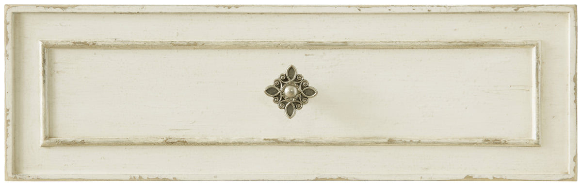 a white drawer with a silver handle