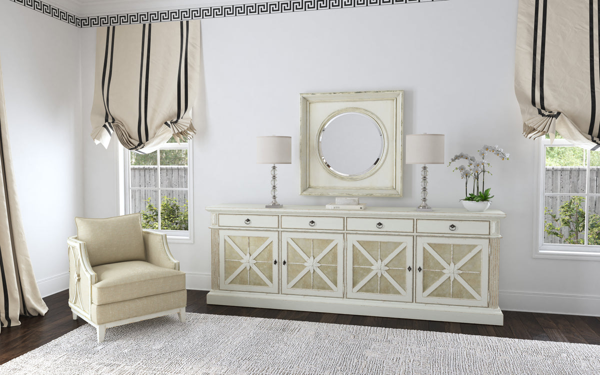 a white dresser with a mirror and a chair in front of it