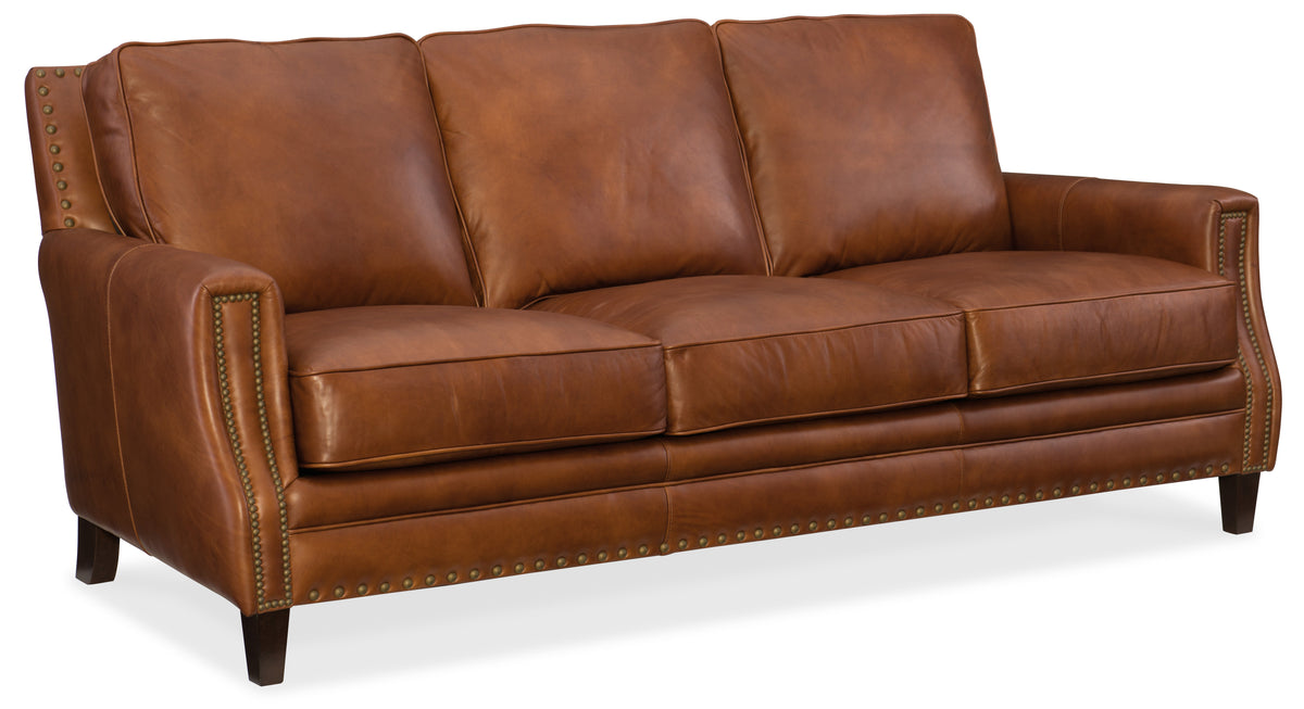 a brown leather couch with studs
