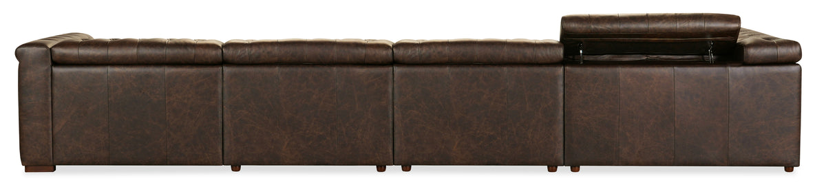 a brown leather couch with wooden legs